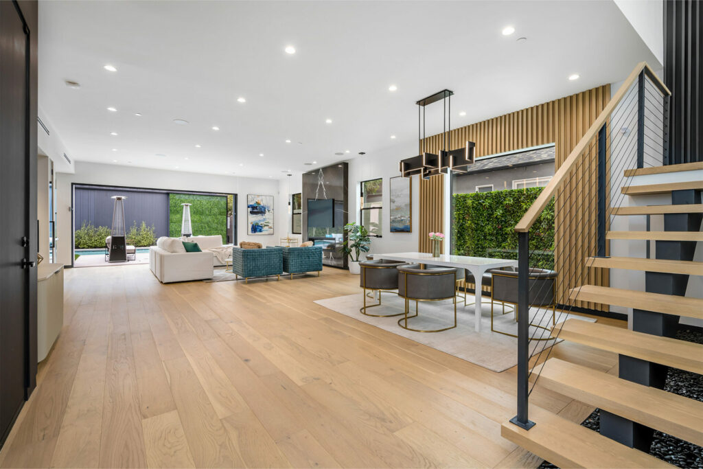 Laminate flooring in a luxury, large living room with a staircase by A&S Carpet Collection in Allison Park, PA.